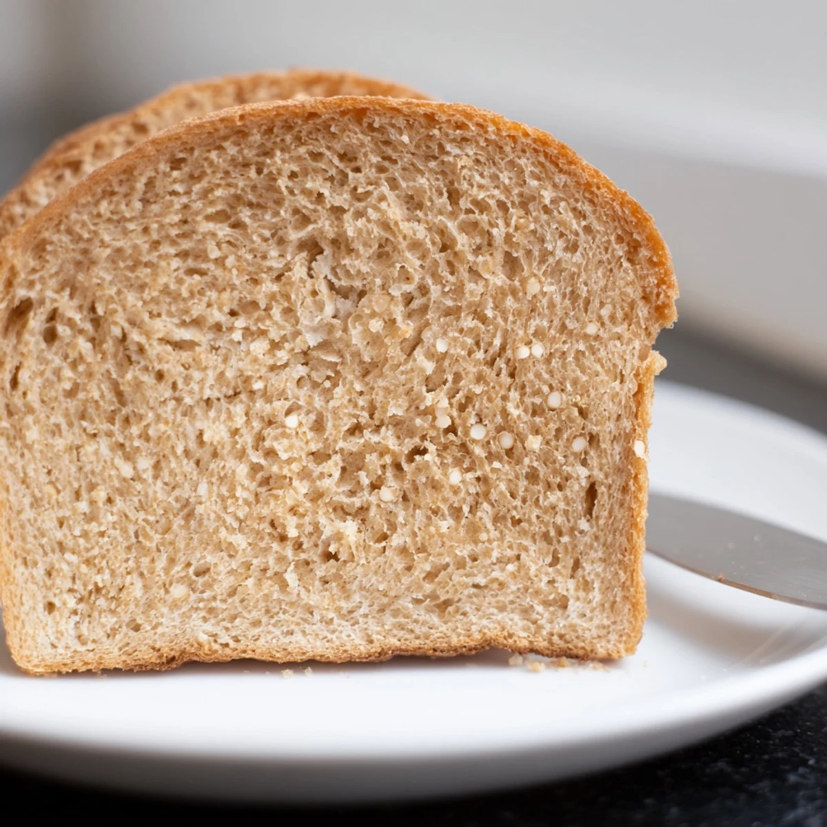 Homemade Easy Whole Wheat Sandwich Bread, sliced and served with your favorite jam.