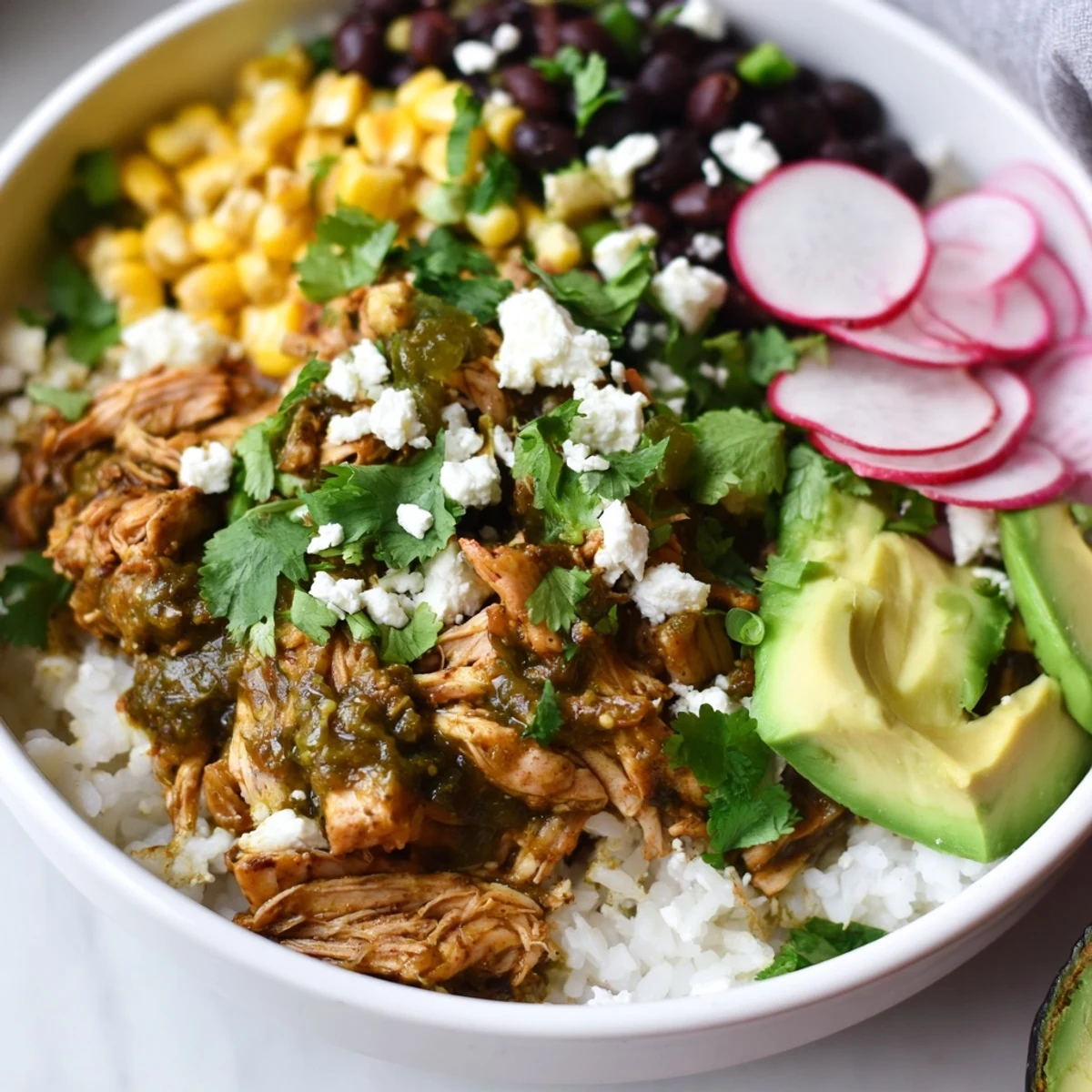 Delicious Green Enchilada Rice Bowl, with vibrant green sauce, shredded chicken, and fresh cilantro, ready to eat.