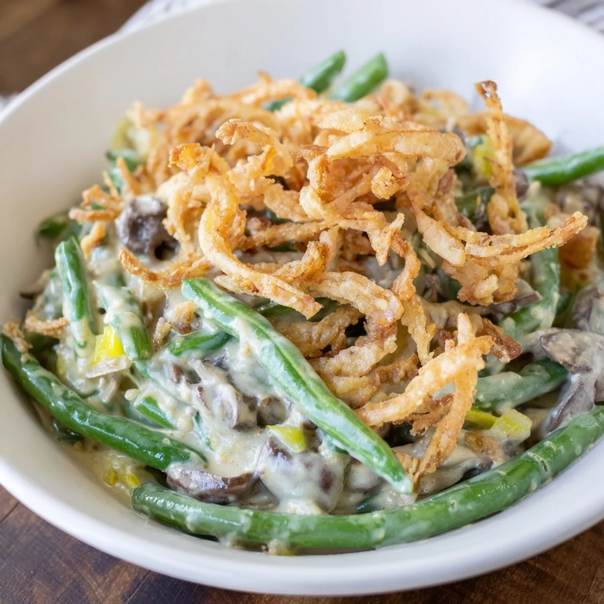Golden, bubbly Old-School Green Bean Casserole with a creamy mushroom sauce and crispy onions.