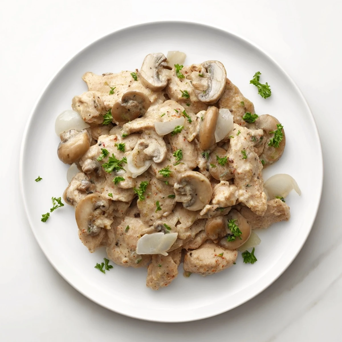 Creamy Chicken Stroganoff, a steaming bowl of tender chicken and earthy mushrooms in a rich sauce.
