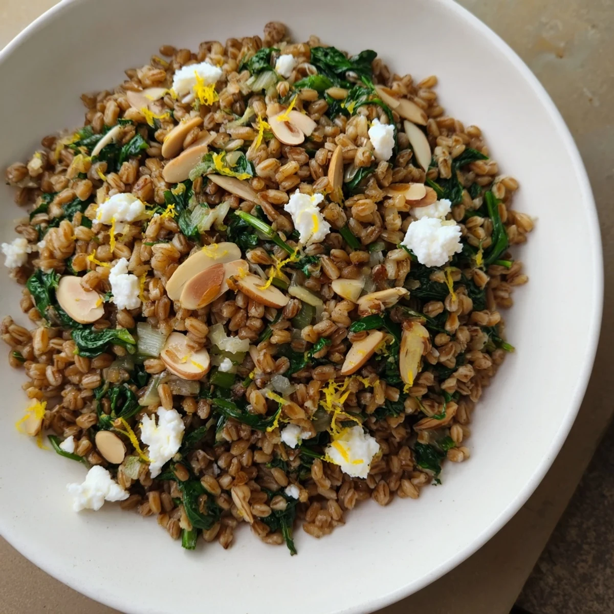 Enjoy a comforting bowl of Warm Farro & Greens Pilaf, perfect as a healthy vegetarian meal.