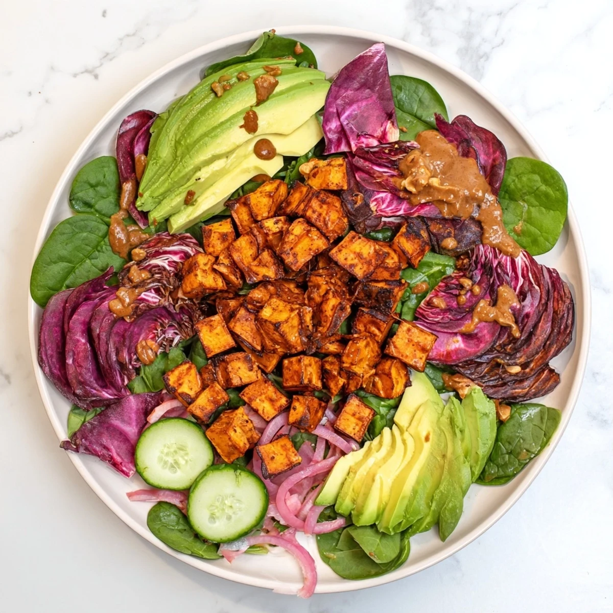 This colorful Spiced Peanut Sweet Potato Salad Bowl shows off warm sweet potatoes and a creamy peanut dressing.