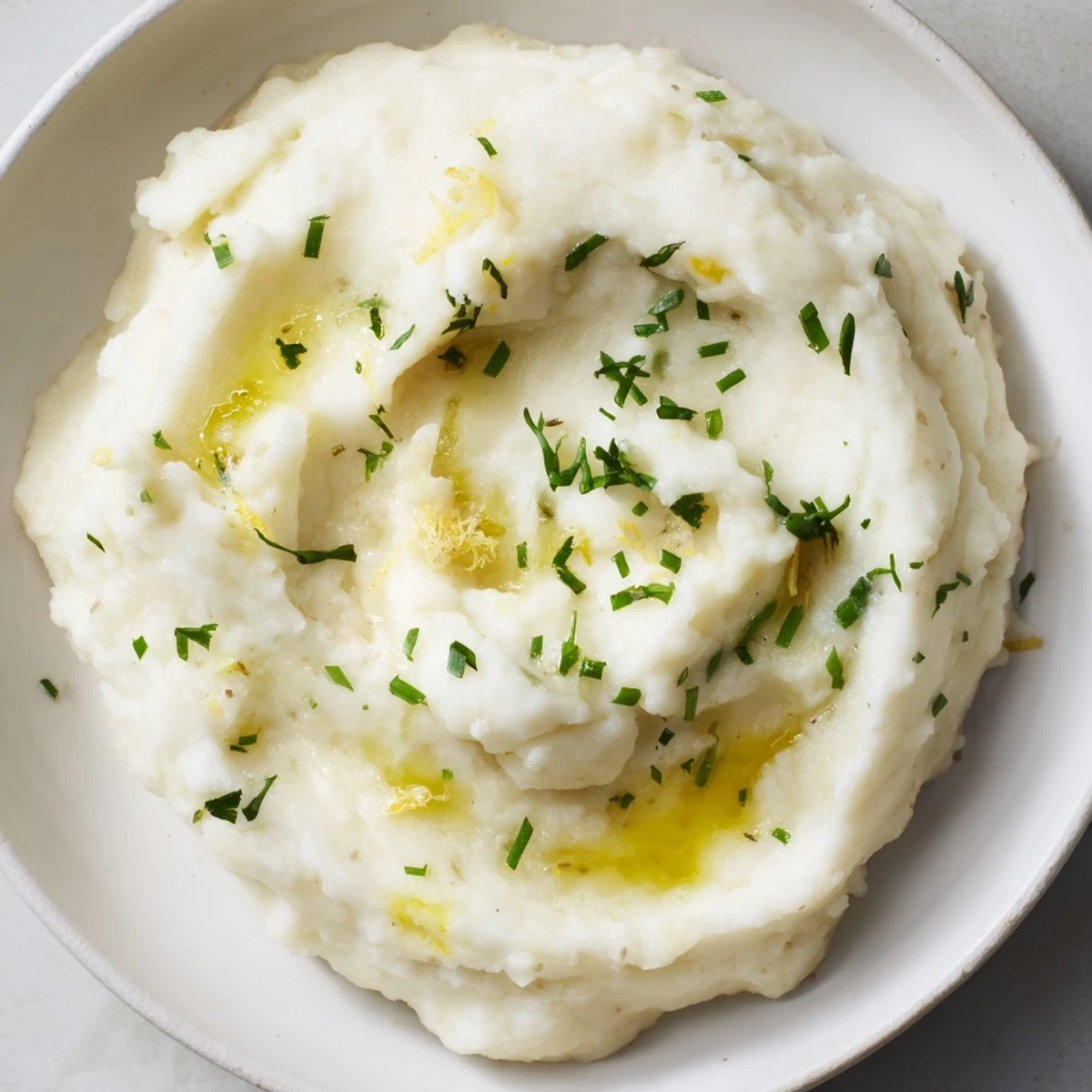Enjoy this comforting garlic and herb cauliflower mash, light yet satisfying for a gluten-free meal.