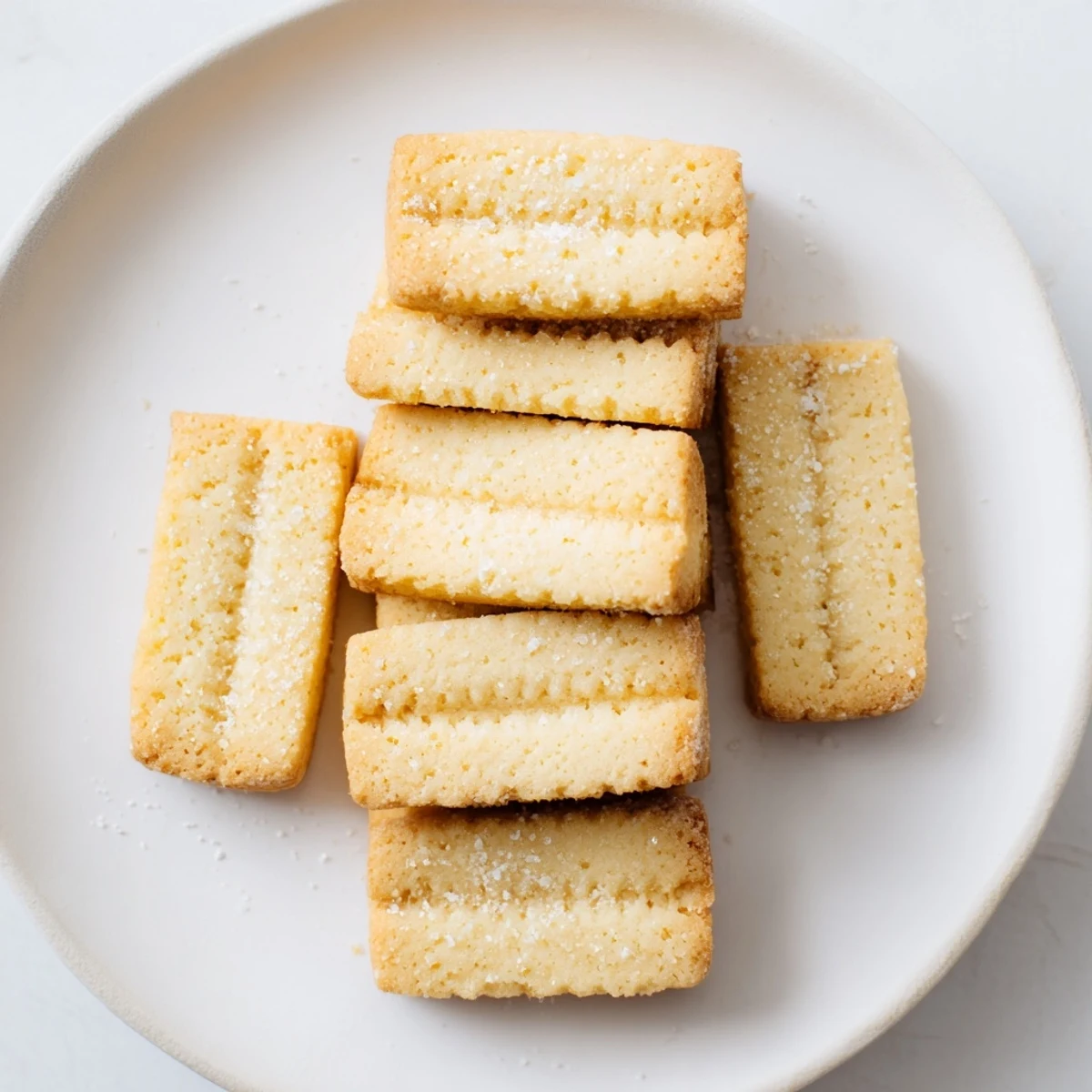 Golden-edged classic shortbread cookies, buttery and crumbly, ready to be enjoyed with a warm drink.