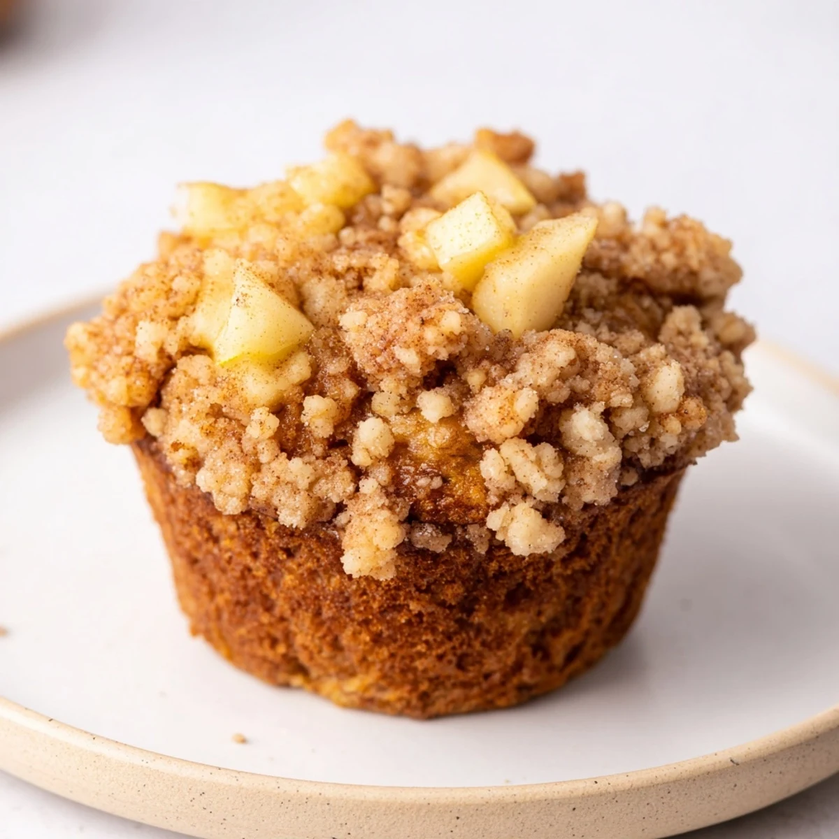 Fluffy and moist Tasty Apple Muffins, studded with apple pieces, and covered in perfect golden crumbs.