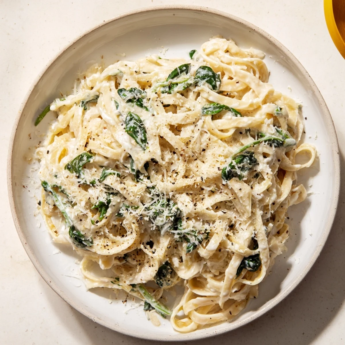 Creamy Greek Yogurt Spinach Alfredo Pasta with vibrant spinach and Parmesan, ready for serving.