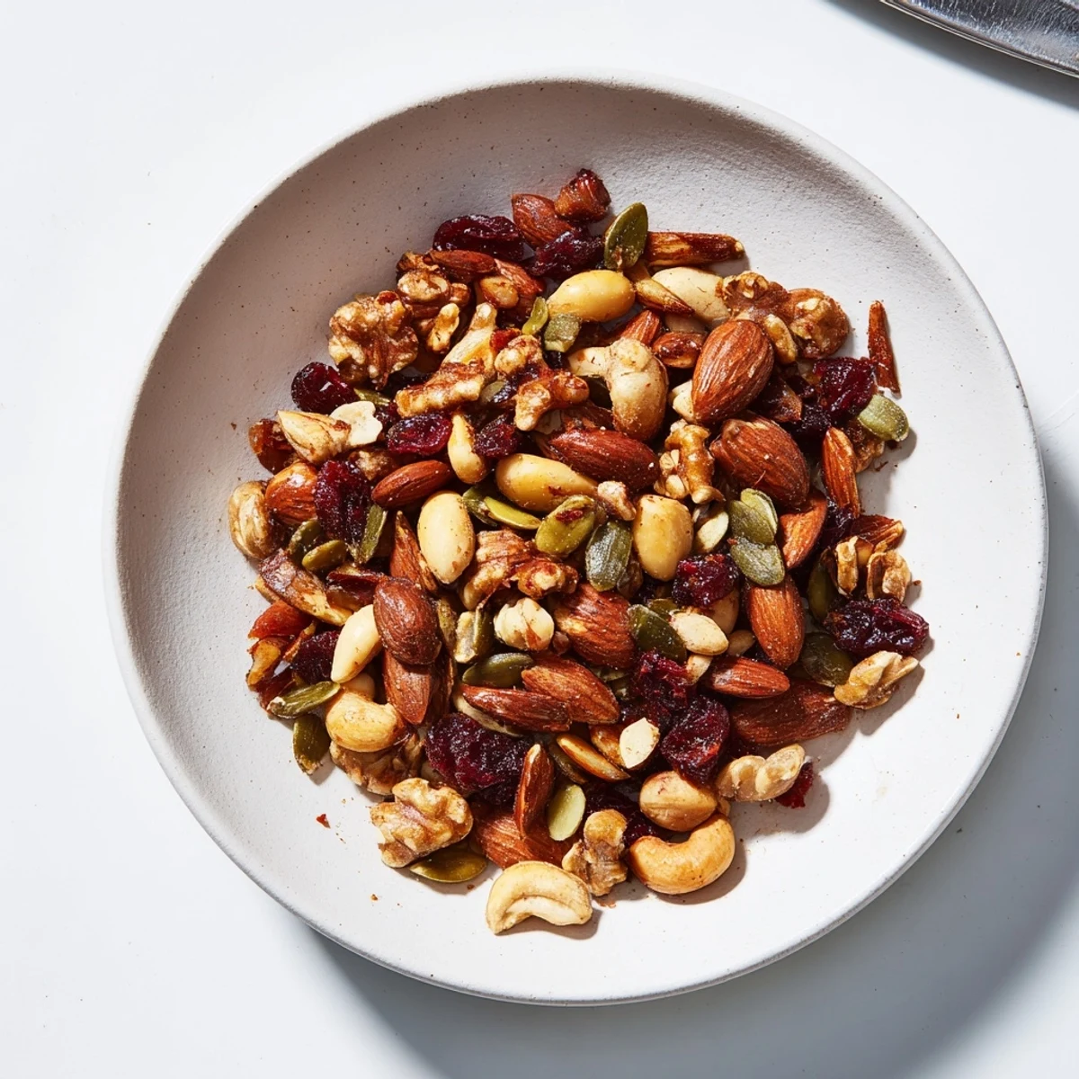 Gourmet Nut Bowl featuring roasted nuts and seeds, a sweet and salty, crunchy snack.