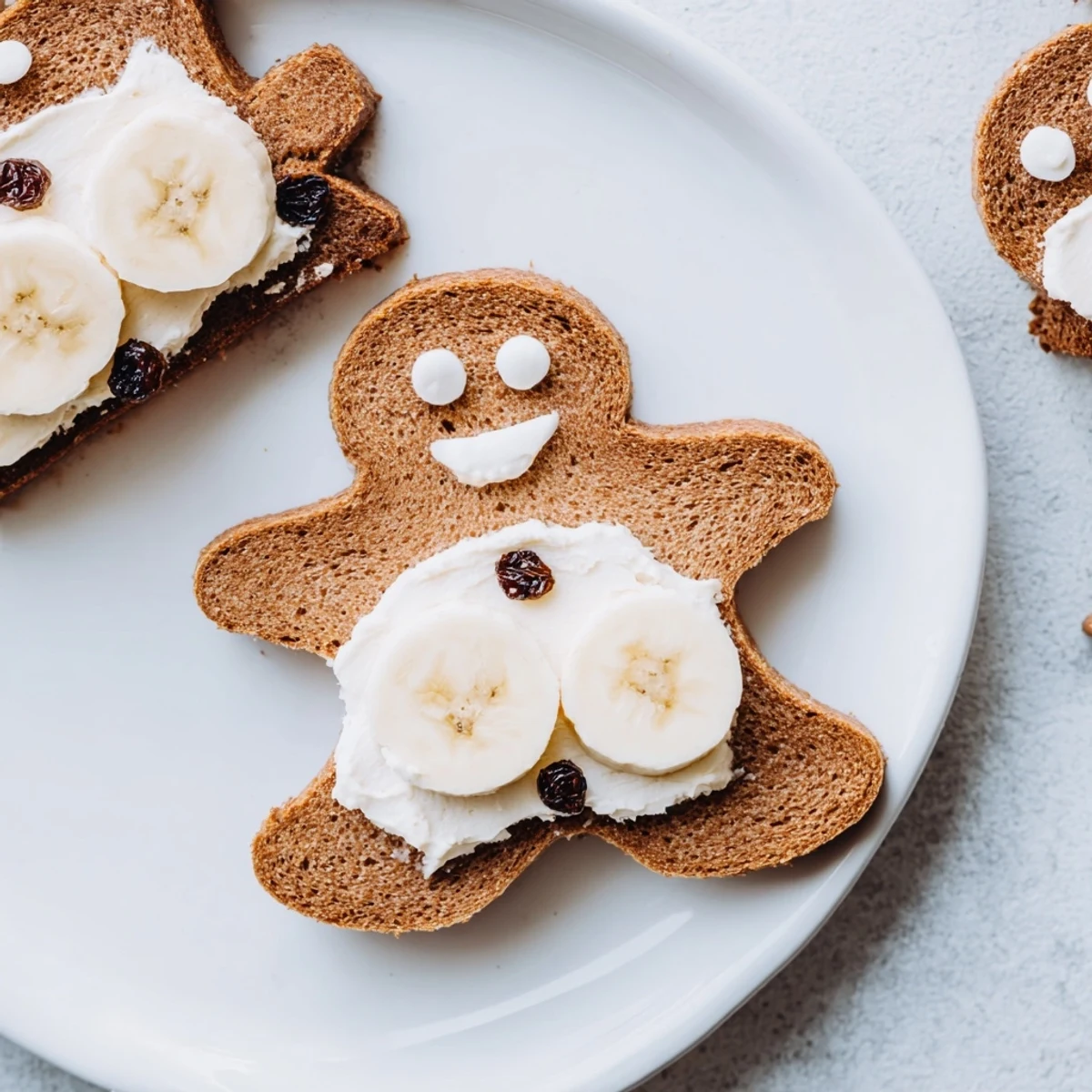 Gingerbread Man Sandwich cutouts, smiling with raisin eyes and apple smiles, perfect for a fun lunch.