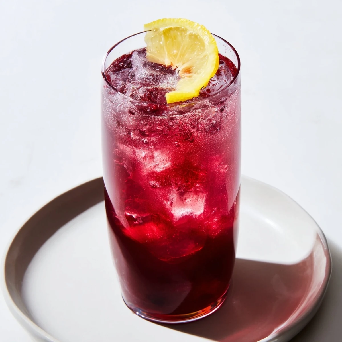 A chilled Sleepy Girl Mocktail: ruby-red tart cherry juice sparkles with effervescence, ready to sip.