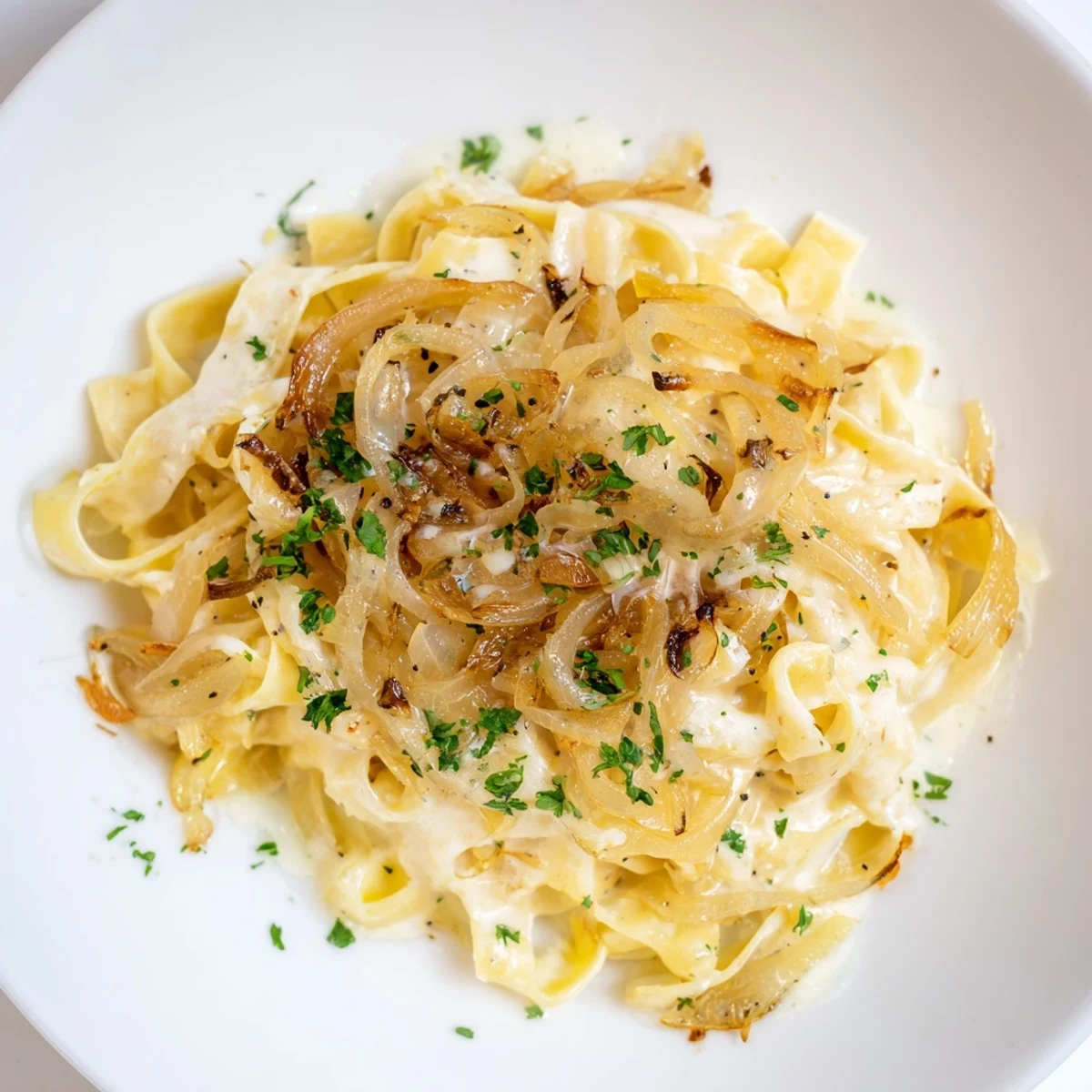 Imagine a close-up of the delicious One-Pot French Onion Pasta, steaming and savory with herbs on top.