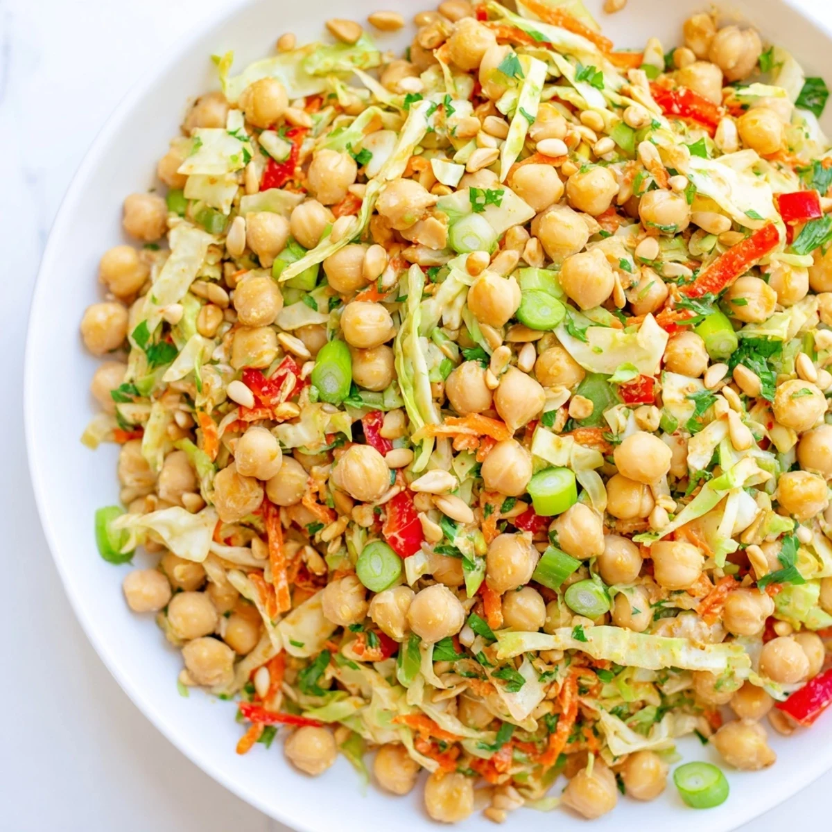 Fiber-forward chickpea salad: A colorful bowl of chickpeas, vegetables, and creamy tahini dressing, ready to eat.