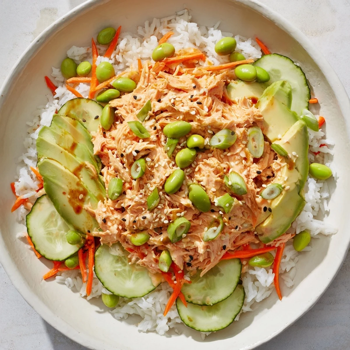 Vibrant Spicy Canned Salmon Rice Bowl with avocado slices, a delightful pescatarian dinner option.