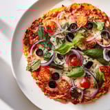A close-up of a perfectly baked Crispy Tortilla Pizza ready to be sliced and enjoyed.
