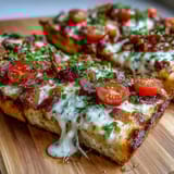 Kentucky Derby Hot Brown Flatbread Pizza with roasted turkey, crispy bacon, and creamy Mornay sauce on golden crust.  