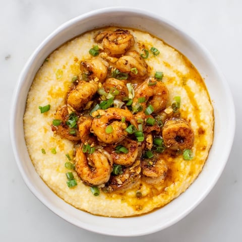 Creamy Cajun shrimp and grits topped with vibrant scallions and savory spices.  