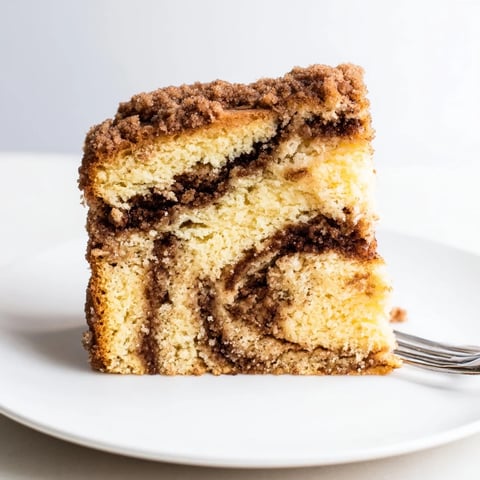 Moist Classic Cinnamon Swirl Coffee Cake topped with buttery streusel, perfect with coffee.  