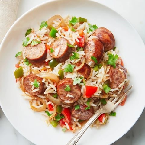 A vibrant One-Pot Cajun Sausage and Rice with colorful veggies and smoky flavors.  