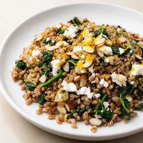 Vibrant Warm Farro & Greens Pilaf, a Mediterranean dish with toasted almonds for delicious texture.