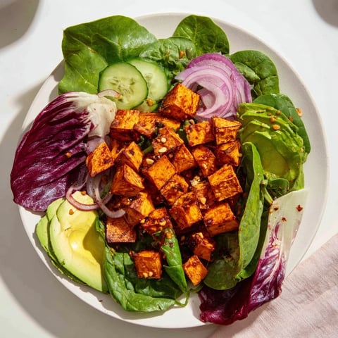 Roasted spiced sweet potatoes, fresh cilantro, and the Spiced Peanut Sweet Potato Salad Bowl's vibrant dressing.