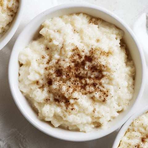 Warm, creamy rice pudding with leftover rice, dusted with cinnamon, perfect for a cozy dessert night.