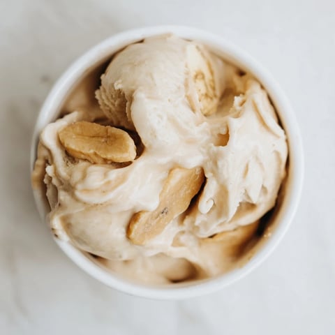Creamy Peanut Butter Banana Ice Cream swirled in a bowl, perfect for a refreshing, dairy-free dessert on a hot day.