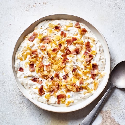 Golden caramelized onions mingle with crispy bacon in savory Caramelized Onion and Bacon Dip.