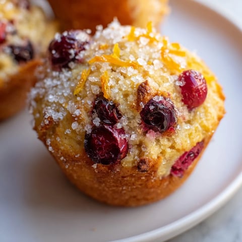 Quick Festive Cranberry Orange Muffins, golden brown and fluffy, perfect for a cozy brunch spread.