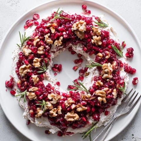 Vibrant Cranberry Feta Dip Wreath, studded with pecans and rosemary, perfect for holiday gatherings.