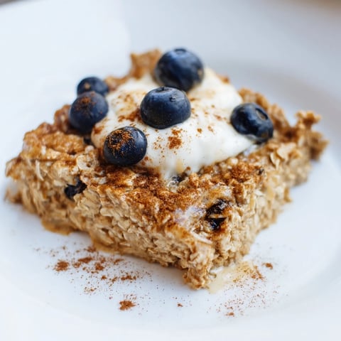 Golden, baked Protein Pancake Oats, fluffy and ready to serve with fresh berries and yogurt.