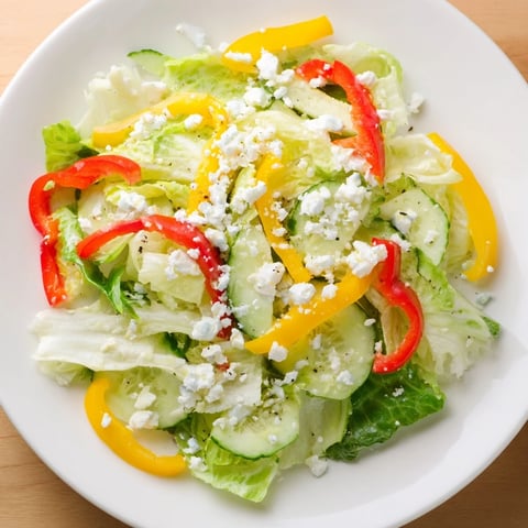 A colorful Bella Hadid Salad, featuring crisp romaine, feta cheese, and a bright lemon vinaigrette.
