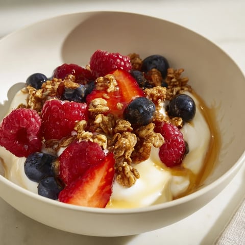 Cottage Cheese Hot Honey Bowl, topped with vibrant berries and crunchy granola, ready to eat now.