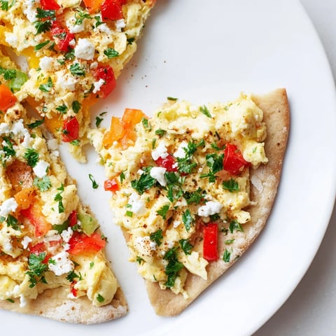 Golden-crusted Turkish Menemen Eggs Pizza topped with vibrant menemen and crumbled feta, ready to serve.
