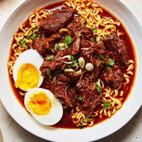 Steaming bowls of Chaos Cooking Birria Ramen, with layers of flavorful broth and toppings.