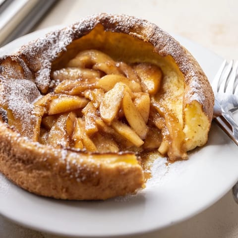 Warm Apple Cinnamon Dutch Baby bursting with tender caramelized apples and sweet cinnamon flavors.  