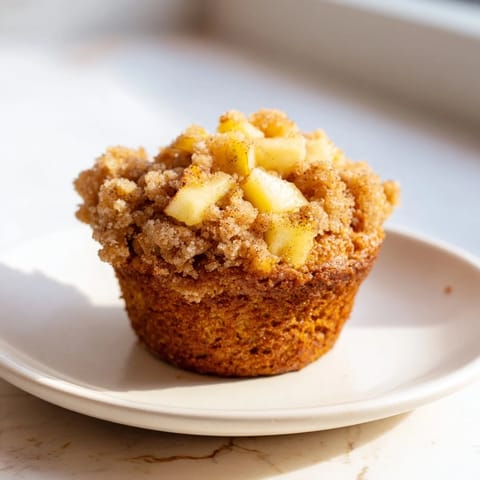 Warm, cinnamon-spiced Tasty Apple Muffins with a delightful, crumbly topping, ideal for brunch.