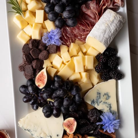 Close-up view of the Celestial Night Board with cheeses, meats, fresh fruits, and cosmic treats for sharing.