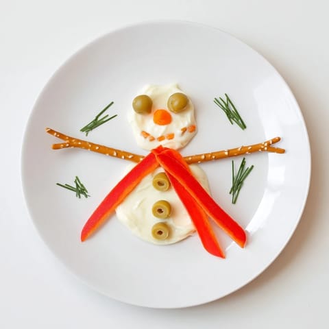 Imagine the charming Melted Snowman Dip Bowl, ready to be scooped up with crackers at your party.