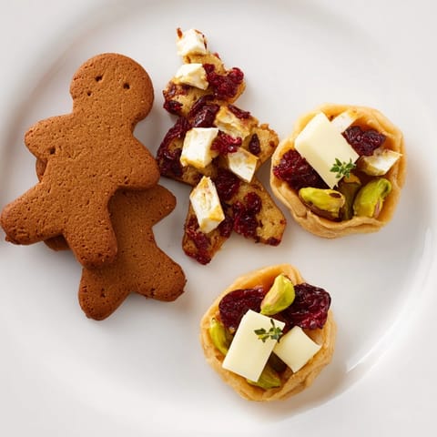 Close-up of Festive Christmas Joy Trios presents a delicious holiday dessert platter overflowing with treats.