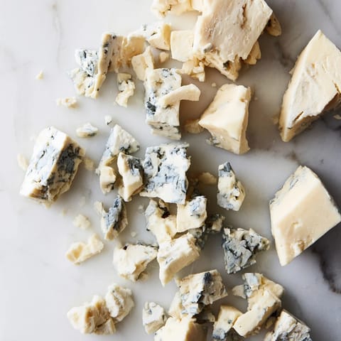 A visually appealing arrangement of The Marble Quarry: blue and white cheeses set out to enjoy.