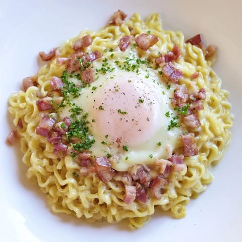 Savory Ramen Carbonara Hack, featuring perfectly cooked ramen with a vibrant, cheesy egg coating; ready in minutes.