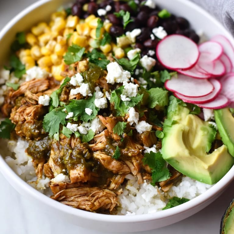 Delicious Green Enchilada Rice Bowl, with vibrant green sauce, shredded chicken, and fresh cilantro, ready to eat.