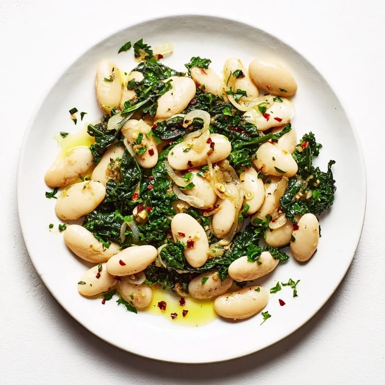 Close-up shot shows flavorful Garlicky Beans with Winter Greens, perfect for a cozy, healthy meal.