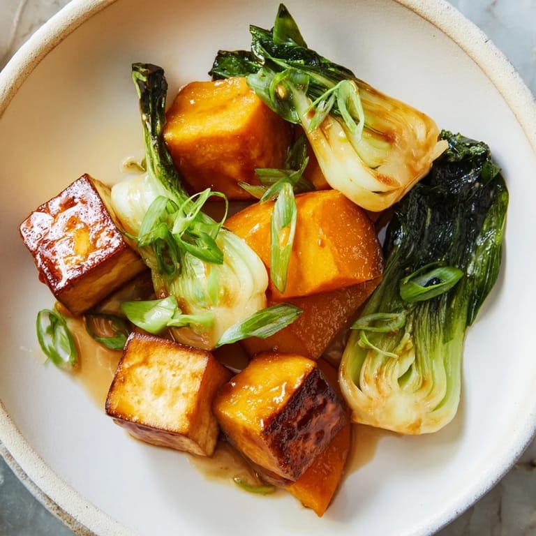 A delicious close-up of Miso-Glazed Tofu with glistening, umami-rich glaze and colorful squash.