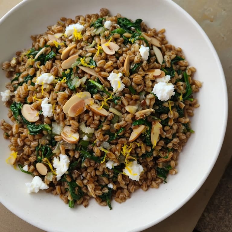 Enjoy a comforting bowl of Warm Farro & Greens Pilaf, perfect as a healthy vegetarian meal.