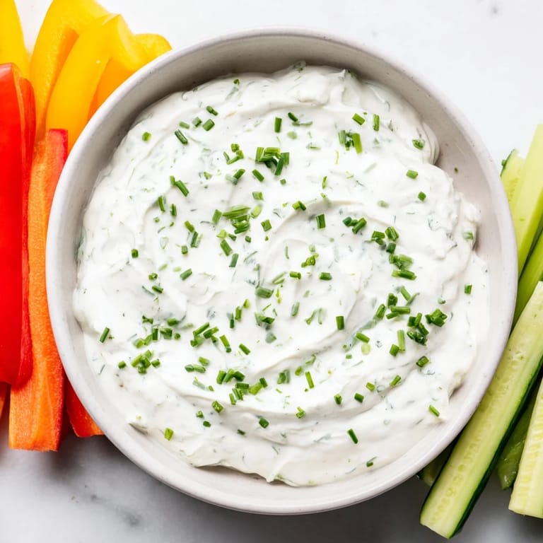A close-up shot of Kids Dip: thick, cool cream cheese and ranch dip with crunchy vegetables.