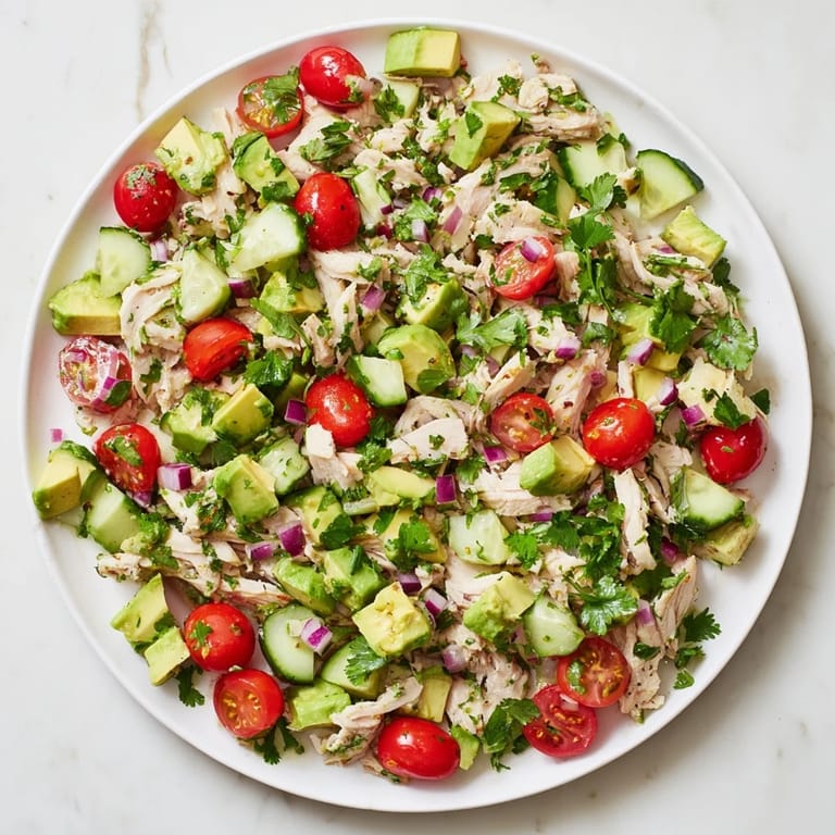 Avocado Chicken Salad served in lettuce cups, topped with herbs, perfect for a light gluten-free lunch.