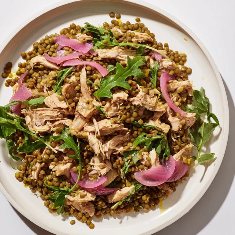 This protein-packed lentil and chicken salad features colorful pickled onions and a light, tangy vinaigrette over a bed of greens.