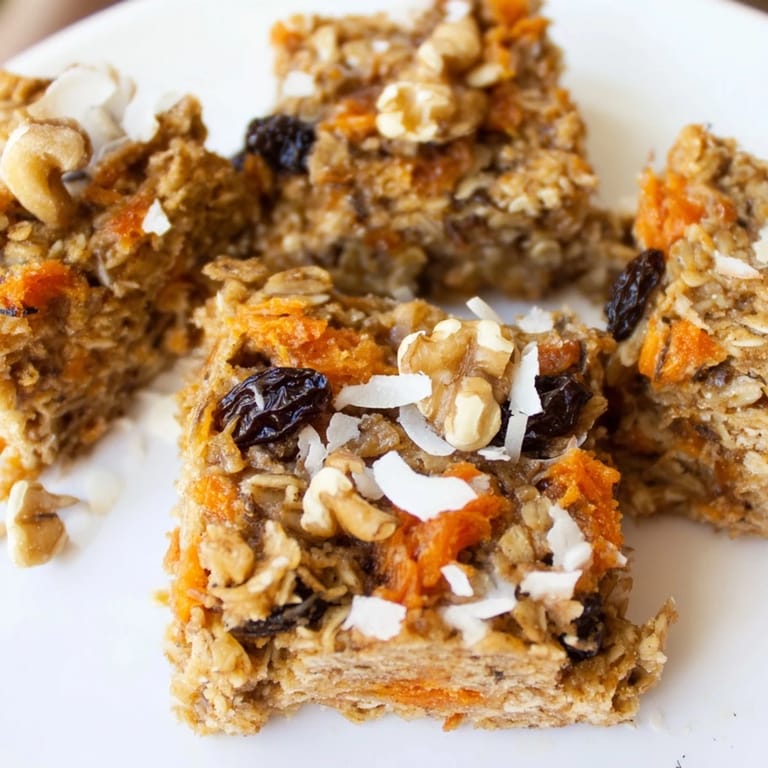 Freshly baked Carrot Cake Baked Oatmeal in a ceramic dish, with grated carrots and shredded coconut visible.