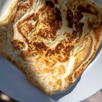 Warm, golden Cottage Cheese Flatbread, perfect for dipping, smells wonderfully of fresh baking.