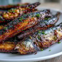Crispy golden catfish fillets seasoned with Southern spices, served with zesty homemade remoulade sauce for a classic soul food dinner.  